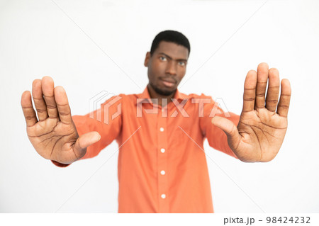 Close-up of male hands making stop gesture over white background 98424232