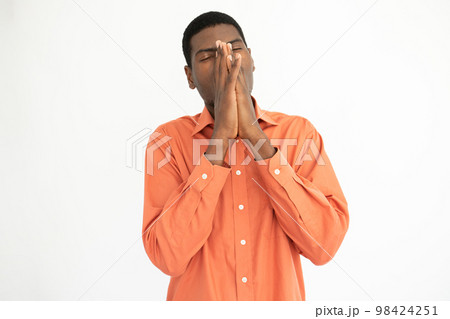 Portrait of tired young man rubbing nose Portrait of tired young man rubbing nose 98424251