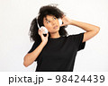 Portrait of concentrated young woman listening to music 98424439