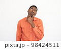 Portrait of thoughtful young man touching chin 98424511