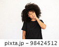 Portrait of stressed young woman touching aching neck 98424512