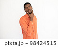 Portrait of confident young man touching chin 98424515