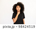 Portrait of displeased young woman touching throat 98424519
