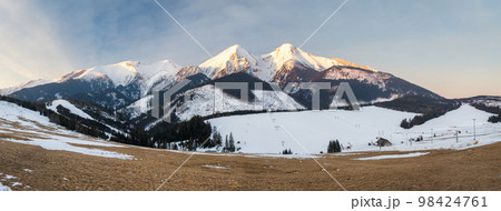 View of the landscape with snowy mountains and ski slopes. 98424761
