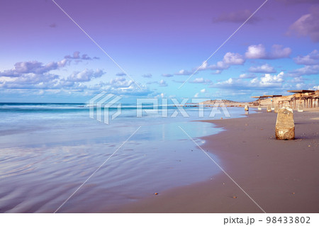 Sunset over the beach. Evening on the empty beach in Caesarea, Israel 98433802