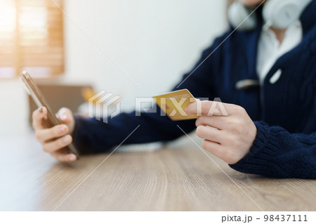 Online Shopping and Internet Payments, Asian man are using their credit card and mobile phone to shop online or conduct errands in the digital world Online Shopping and Internet Payments, Asian man are using their credit card and mobile phone to shop online or conduct errands in the digital world 98437111