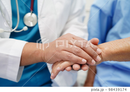 Doctor holding hands Asian elderly woman patient, help and care in hospital. Doctor holding hands Asian elderly woman patient, help and care in hospital. 98439174