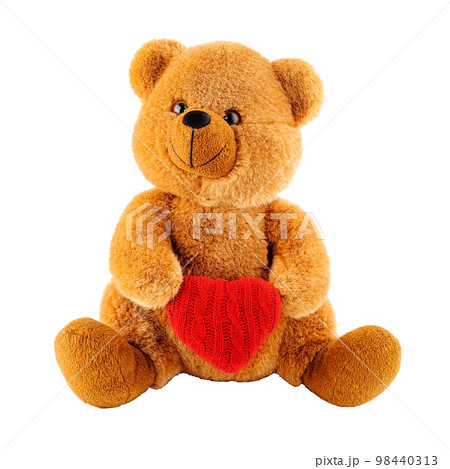 Soft toy teddy bear holding a heart-shaped pillow isolated Soft toy teddy bear holding a heart-shaped pillow isolated 98440313