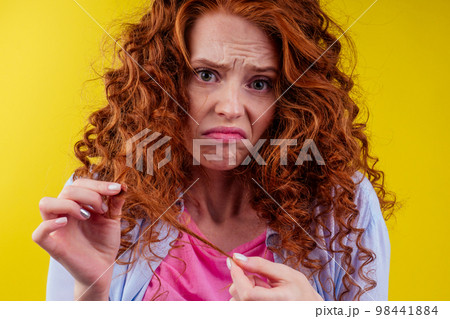 upset redhaired ginger foxy woman with dryness tangled red hair 98441884