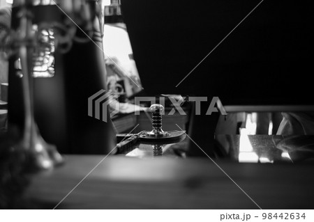 Selective focus on the metal equipment for manually pressing the coffee powder for making the fresh coffee at the cafe. Selective focus on the metal equipment for manually pressing the coffee powder for making the fresh coffee at the cafe. 98442634