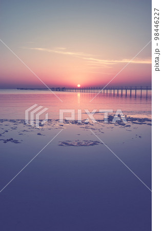 Seascape with a wooden pier silhouette at sunset, color toning applied. Seascape with a wooden pier silhouette at sunset, color toning applied. 98446227