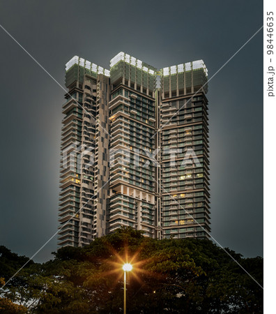 View of Modern condominium residential or Commercial mong green trees space with sky background. 98446635