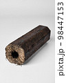 Wooden pressed briquette Pini Kay from biomass on a white 98447153