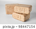 Wood briquettes (ruf type), made of beech and oak burning inside the wood fuel boiler. 98447154