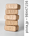 Five wooden briquettes (ruf type) on white background. 98447156