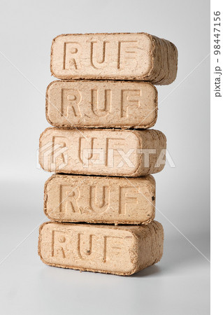 Five wooden briquettes (ruf type) on white background. Five wooden briquettes (ruf type) on white background. 98447156