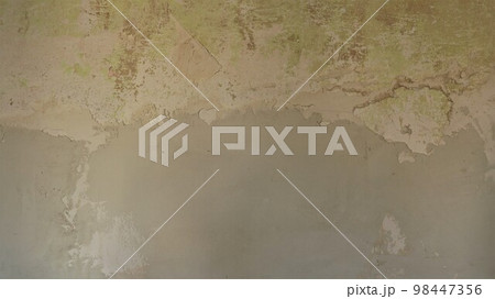 empty texture wall with peeled off remnants of green paint plastered from below with fresh putty as a surface in the process of repair, renovation of walls with fresh finishing plaster example empty texture wall with peeled off remnants of green paint plastered from below with fresh putty as a surface in the process of repair, renovation of walls with fresh finishing plaster example 98447356