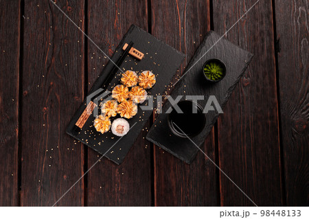 Maki sushi roll with eel served on black board top view - Japanese food 98448133