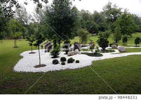 Garden design, with hard landscaping, using shaping, paving, rocks and pebbles 98448231