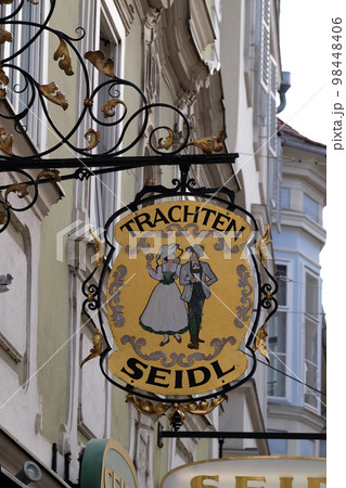 Old shop sign for Trachten Seidl made of wrought iron, hanging outside shop in the old town of Graz, Styria, Austria Old shop sign for Trachten Seidl made of wrought iron, hanging outside shop in the old town of Graz, Styria, Austria 98448406