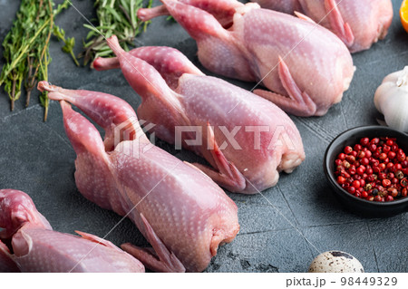 Homemade eco friendly raw quails, on grey background Homemade eco friendly raw quails, on grey background 98449329