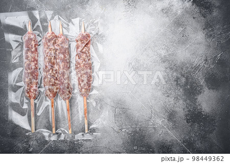 Packed kebab from lamb or mutton meat, on gray stone table background, top view flat lay, with copy space for text 98449362