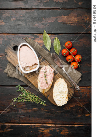Chicken liver pate sandwich baguette, on old dark rustic table background, top view flat lay, with copy space for text 98449984