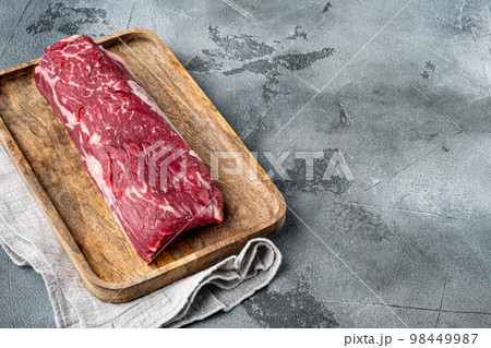 Fresh Raw Beef steak Mignon whole cut, on gray stone background, with copy space for text 98449987
