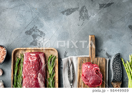 Tenderloin fillet mignon whole cut, on gray stone background, top view flat lay, with copy space for text 98449989