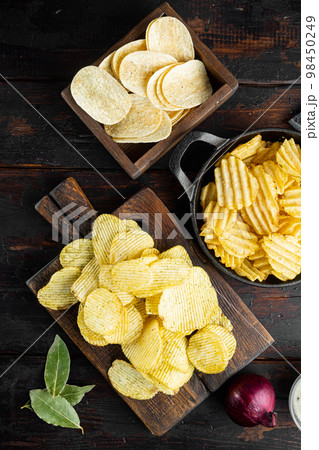 Variation different potato chips, on old dark  wooden table , top view flat lay 98450249