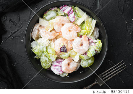 Prawn Waldorf salad , with sauce apple and grape, on black stone background, top view flat lay 98450412