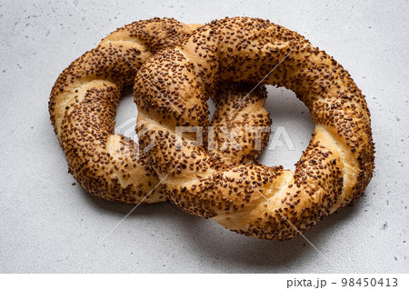 Turkish bagel Simit with sesame, on gray concrete table background, with copy space for text 98450413