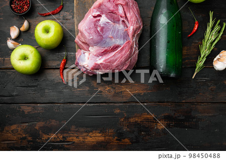 Pork roast ingredients, with apple dry cider, on old dark  wooden table background, top view flat lay, with copy space for text 98450488