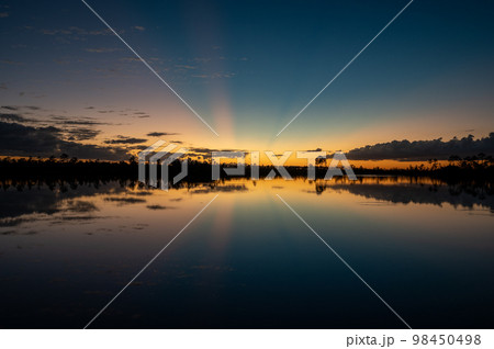 Twilight sun rays over Pine Glades Lake in Everglades National Park. Twilight sun rays over Pine Glades Lake in Everglades National Park. 98450498