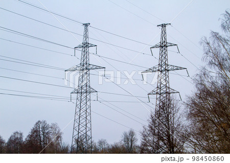 New large mast of an air power line close up, high voltage electricity pylon with thick wires and insulators, blue sky on background. Traditional energy. Electric power concept. New large mast of an air power line close up, high voltage electricity pylon with thick wires and insulators, blue sky on background. Traditional energy. Electric power concept. 98450860