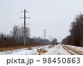 New large mast of an air power line close up, high voltage electricity pylon with thick wires and insulators, blue sky on background. Traditional energy. Electric power concept. 98450863