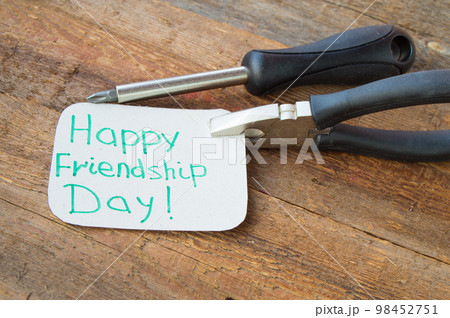 Tags happy friendship day and tools on the old wooden background 98452751