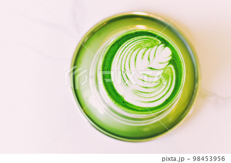 Matcha latte with latte art, A cup of japanese green tea in cafe, Healthy anti-aging drink. 98453956