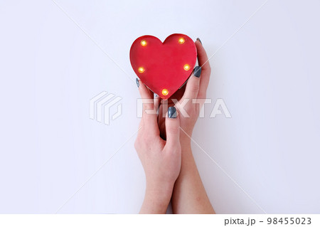 top view woman hands holding heart white background  98455023