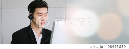 Business people wearing headset working in office in widen view 98455839