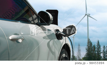 Progressive electric vehicle powered by clean energy generated by wind turbine. Progressive electric vehicle powered by clean energy generated by wind turbine. 98455994