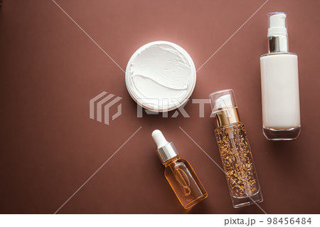 Skincare cosmetics and anti-aging beauty products, luxury skin care bottles, oil, serum and face cream on brown background. 98456484