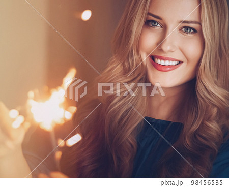 Holiday magic, Christmas and New Year celebration, happy woman with sparklers, portrait 98456535