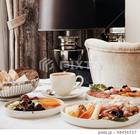 Luxury hotel and five star room service, various food platters, bread and coffee as in-room breakfast for travel and hospitality brand Luxury hotel and five star room service, various food platters, bread and coffee as in-room breakfast for travel and hospitality brand 98456537