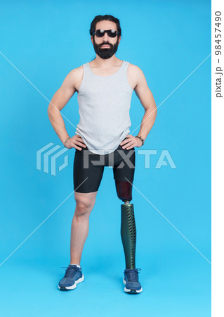 Man with sunglasses standing with a prosthetic leg 98457490