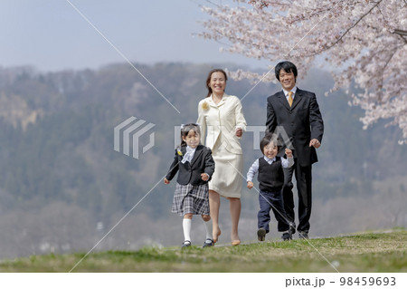 桜の咲く遊歩道を歩く入学入園の親子 桜の咲く遊歩道を歩く入学入園の親子 98459693