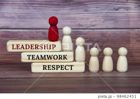 Leadership concept - Leadership, teamwork and respect text on wooden blocks with red and white doll figure on wooden cover background Leadership concept - Leadership, teamwork and respect text on wooden blocks with red and white doll figure on wooden cover background 98462451