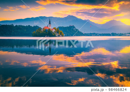 Magical sunrise with colorful clouds over the lake Bled, Slovenia Magical sunrise with colorful clouds over the lake Bled, Slovenia 98466824