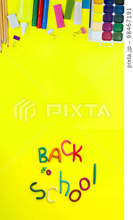 banner letters made of multi-colored plasticine back to school in funny style on yellow background 98467191