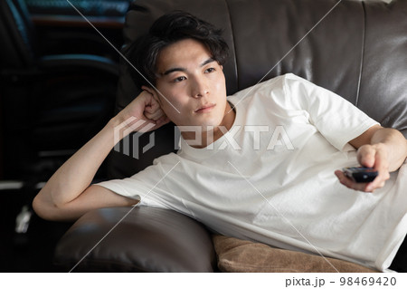 ぼんやりテレビを見る男性 98469420